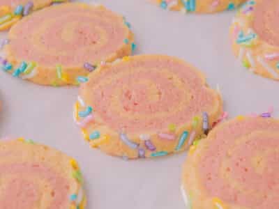 old fashioned pink pinwheel cookies on a baking sheet