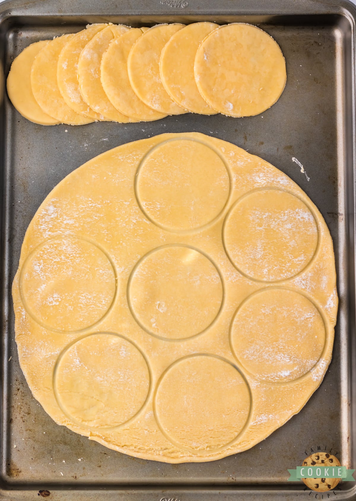 Cutting circles out of pie crust.