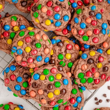 chocolate pudding cookies topped with M&Ms on a cooling rack