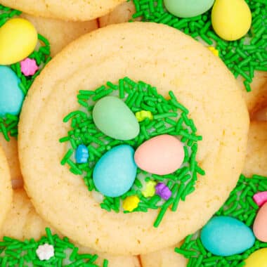 Easter sugar cookies topped with green jimmies and candy eggs