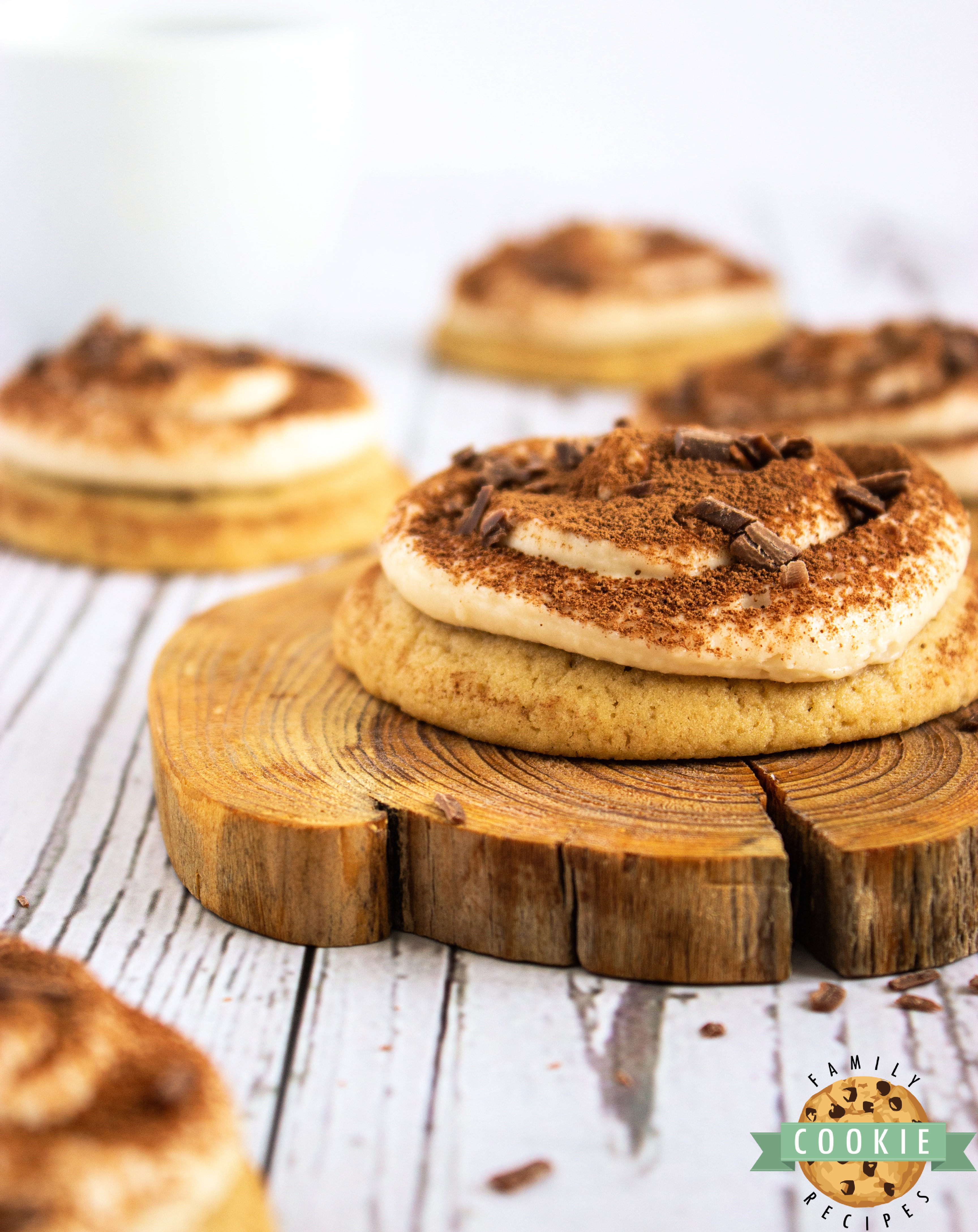 Cookies topped with mascarpone frosting and cocoa powder.