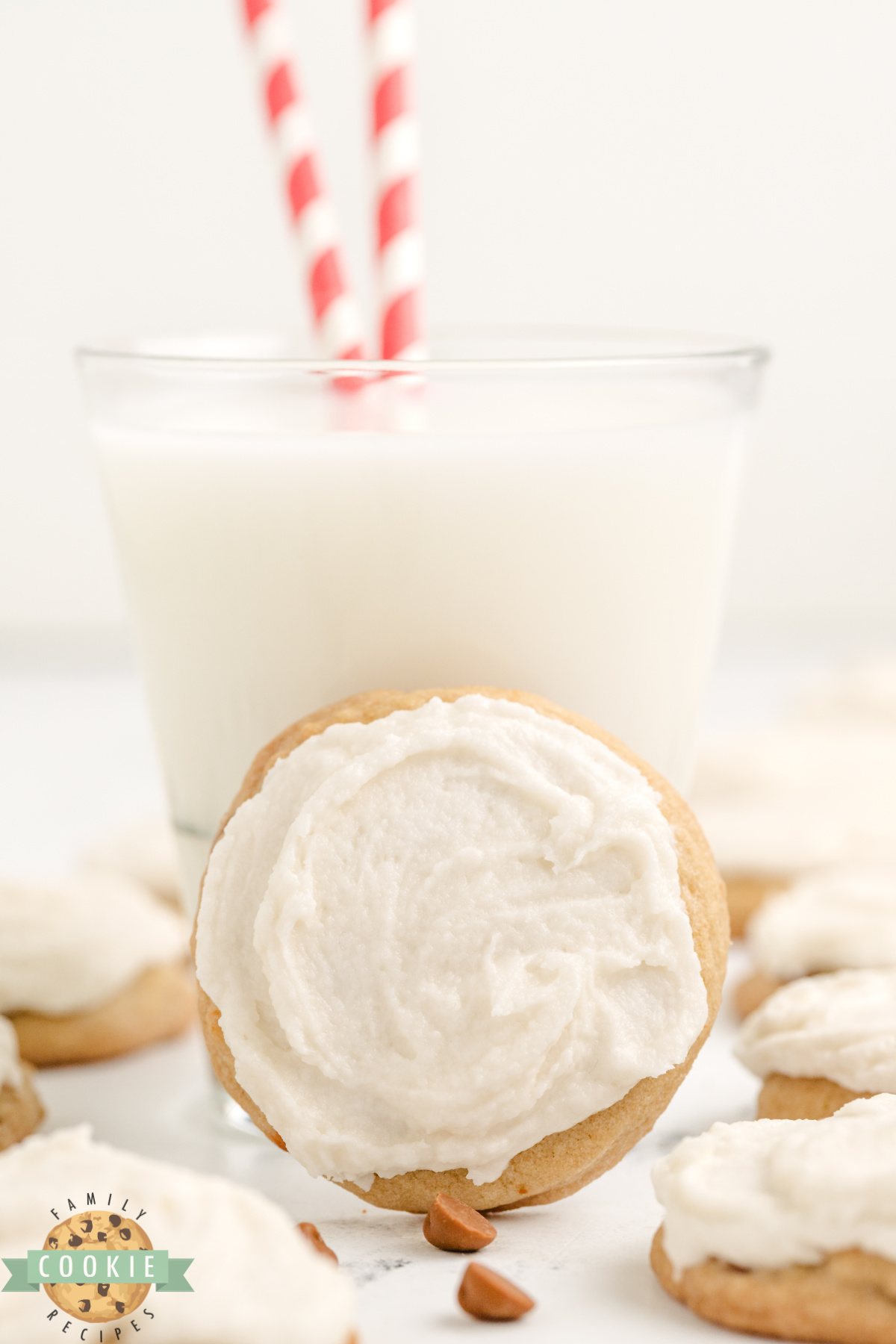 Frosted cookie with a glass of milk.