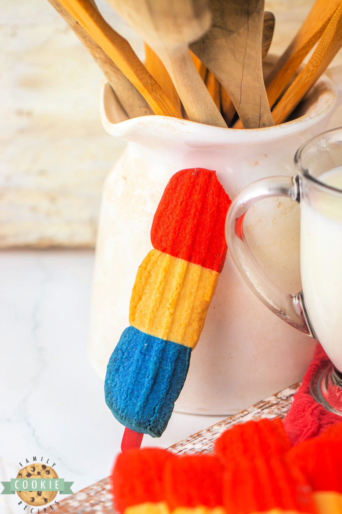 Red, white, and blue cookie on a popsicle stick.
