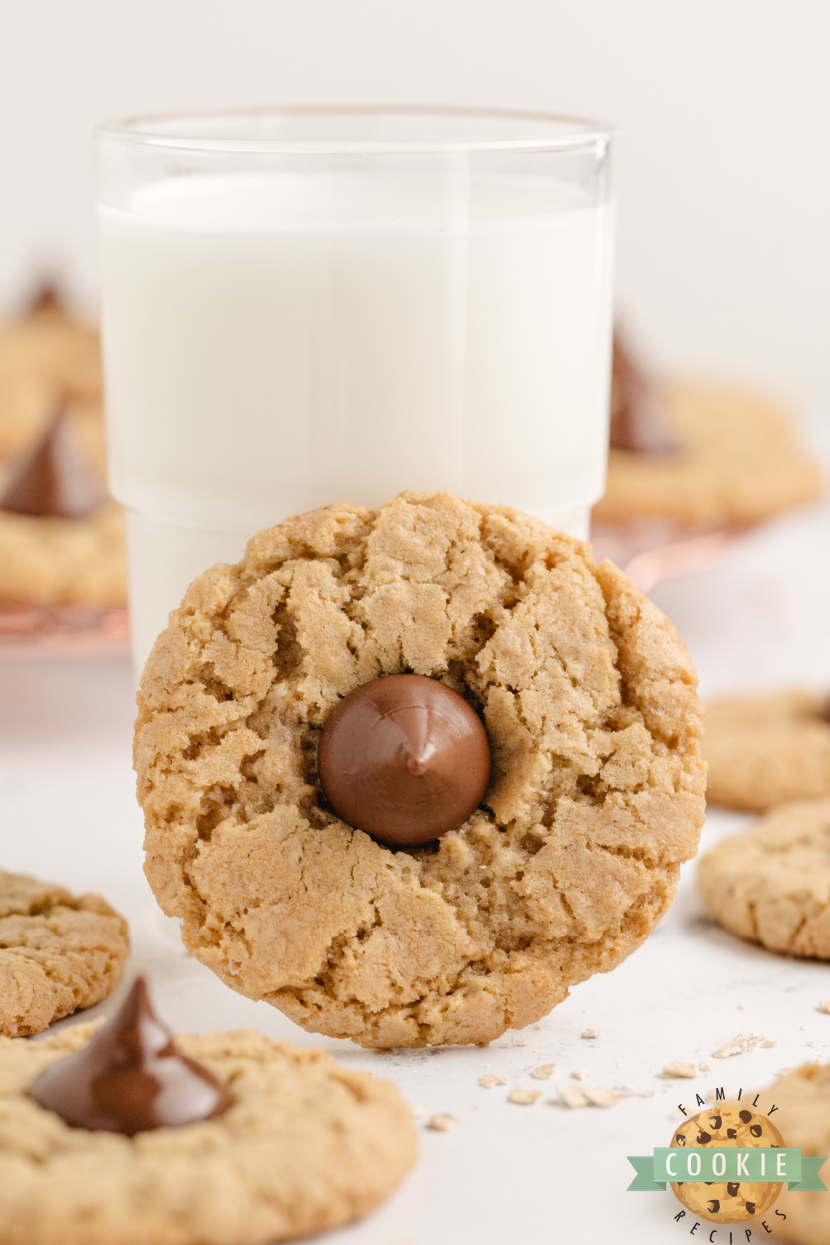 Glass of milk with an oatmeal cookie topped with a Hershey kiss.