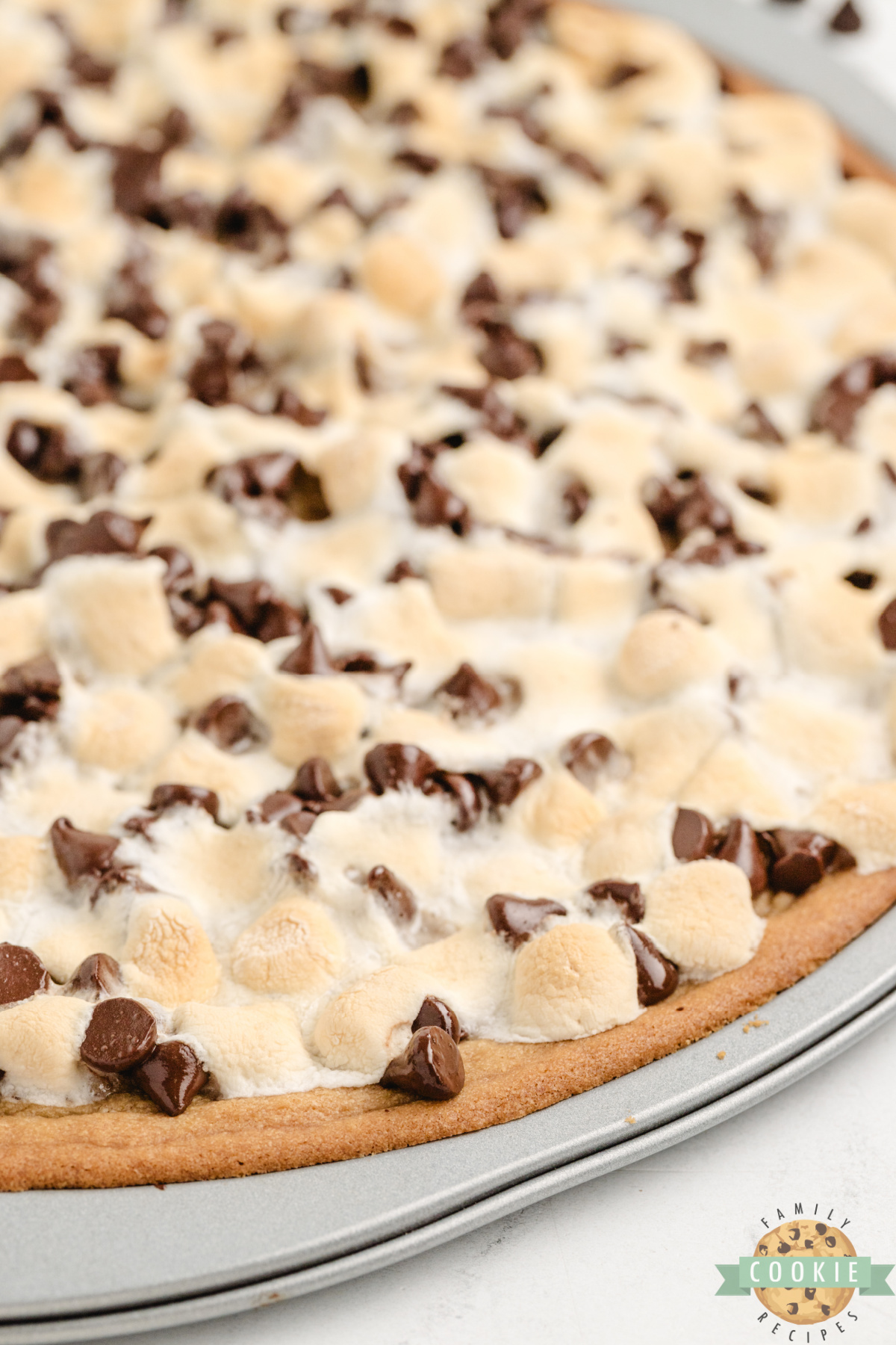 Peanut Butter Cookie Pizza is chewy, gooey, and loaded with marshmallows and chocolate. A fast, fun dessert everyone will love!