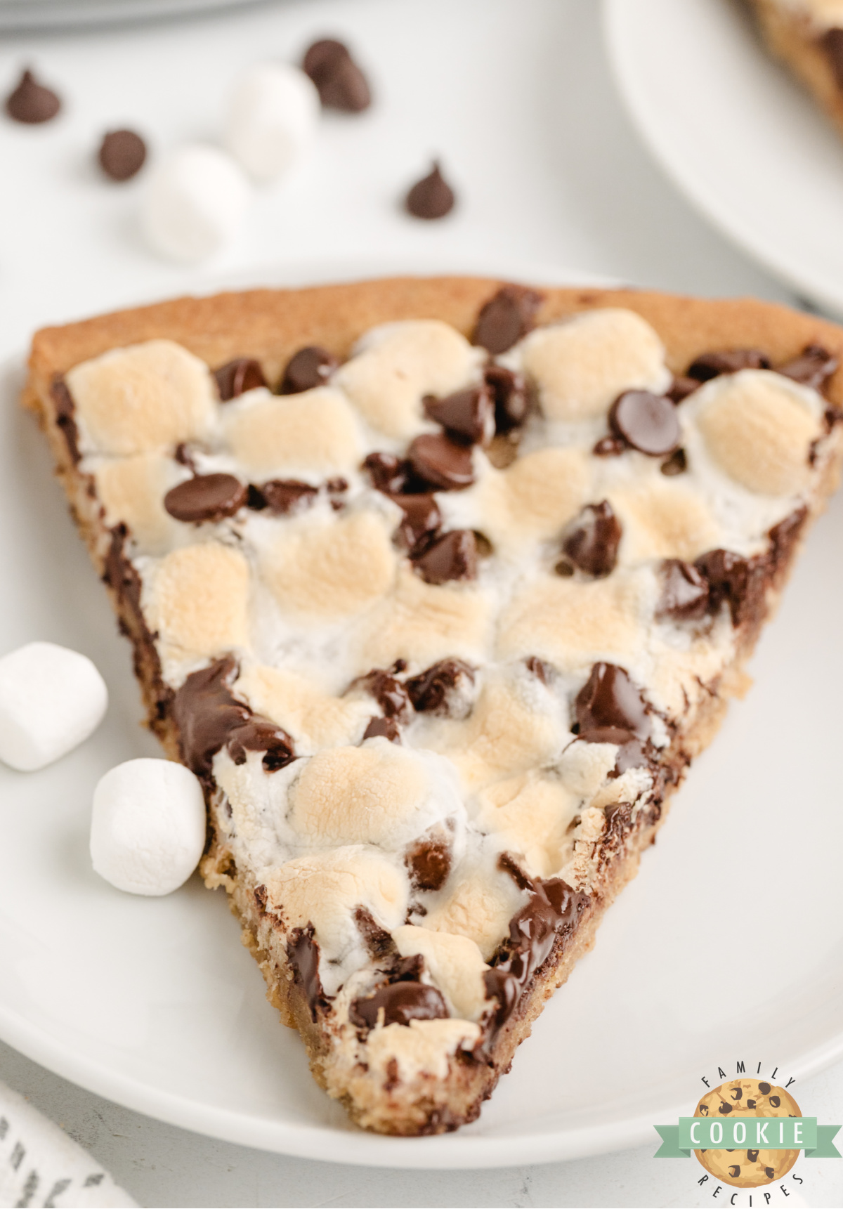 Peanut butter cookie pizza topped with chocolate chips and marshmallows.