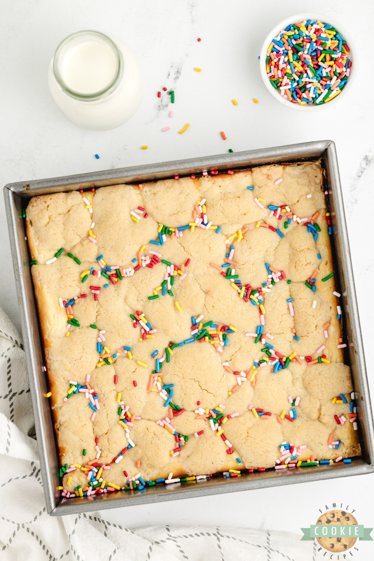 Sugar cookie bars with sprinkles and cheesecake filling.