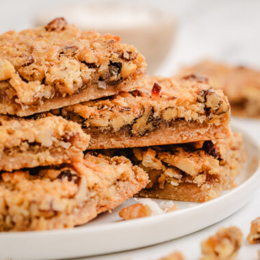 stack of coconut dream bars on a white plate