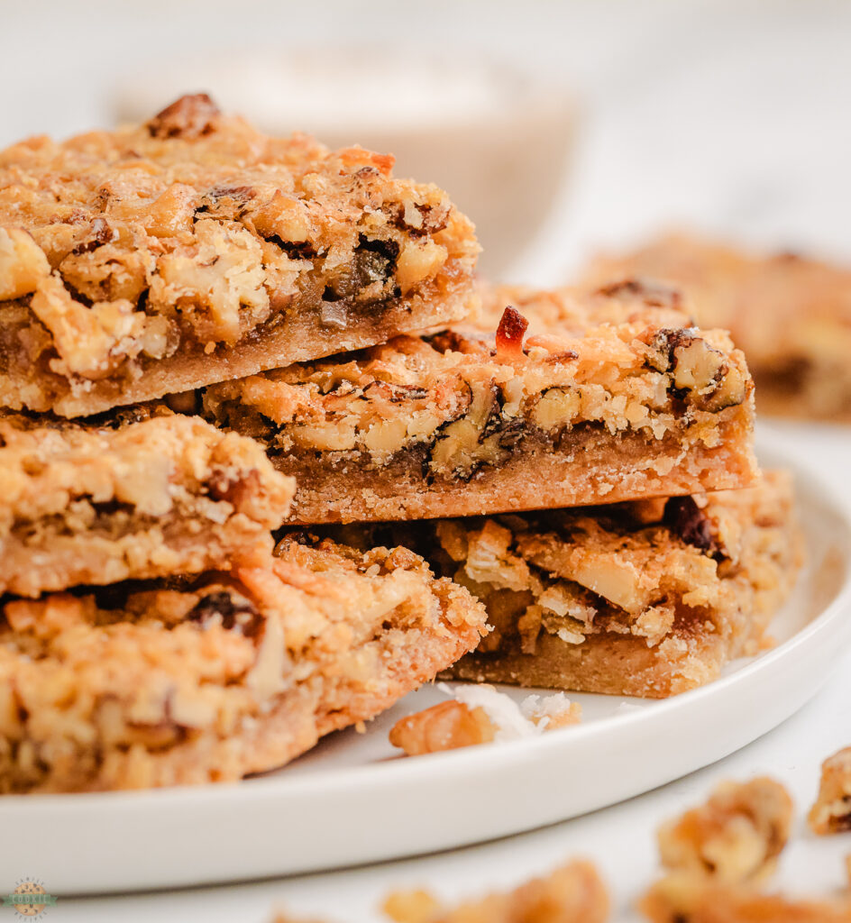 stack of coconut dream bars on a white plate