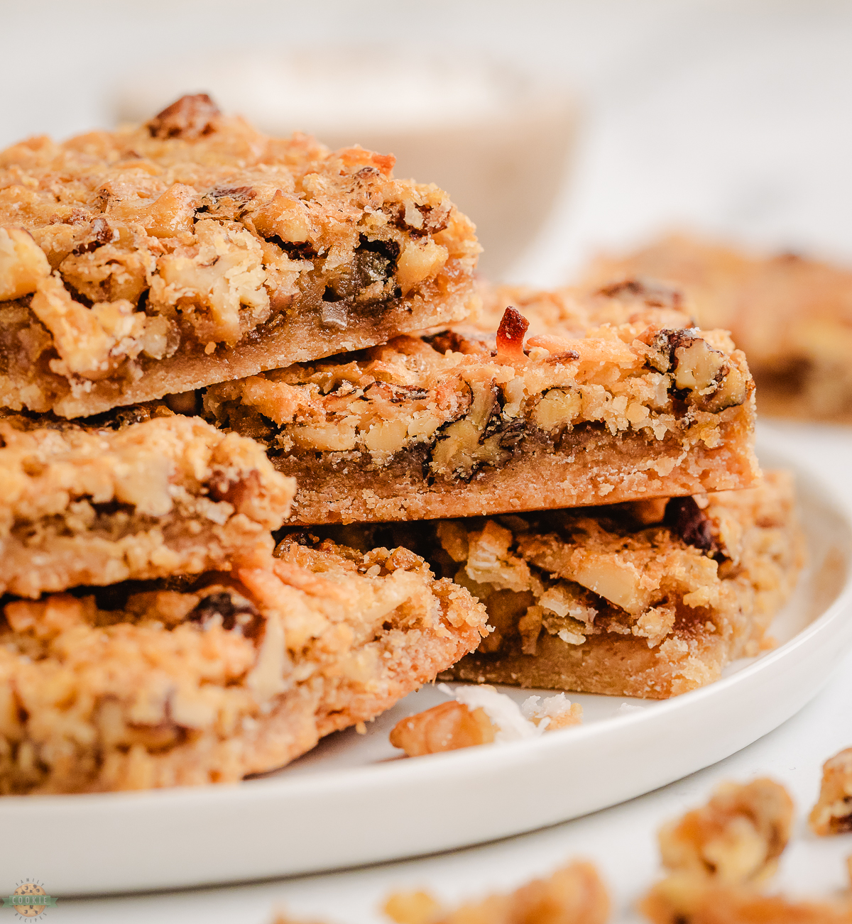 stack of coconut dream bars on a white plate