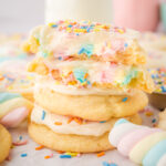 rainbow marshmallow surprise cookies topped with frosting