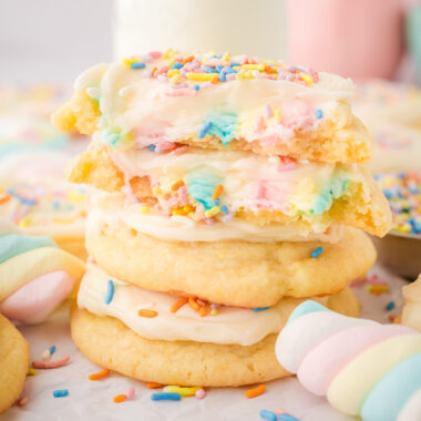 rainbow marshmallow surprise cookies topped with frosting