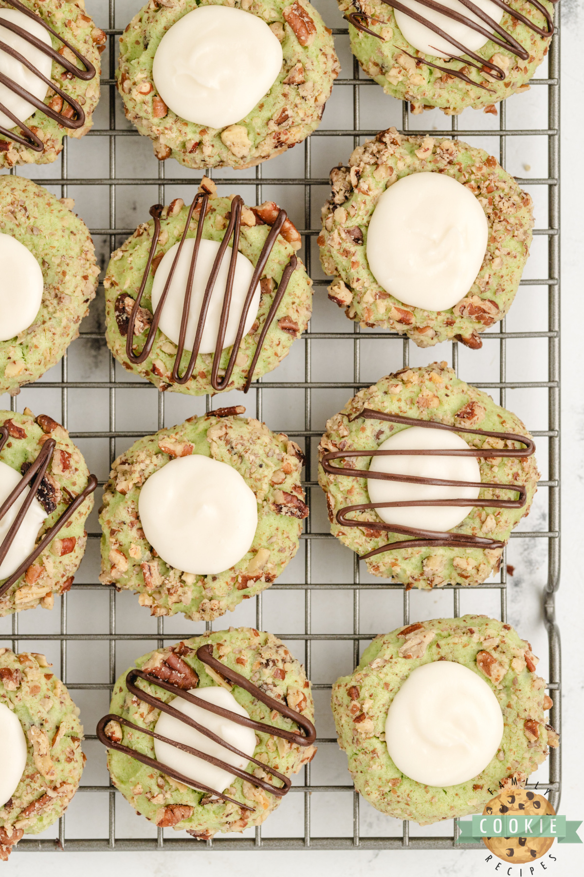 Pistachio Thumbprint Cookies on a wire rack.
