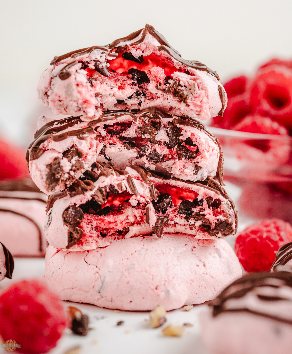 stack of raspberry meringues with chocolate chips and nuts, with a bite taken out