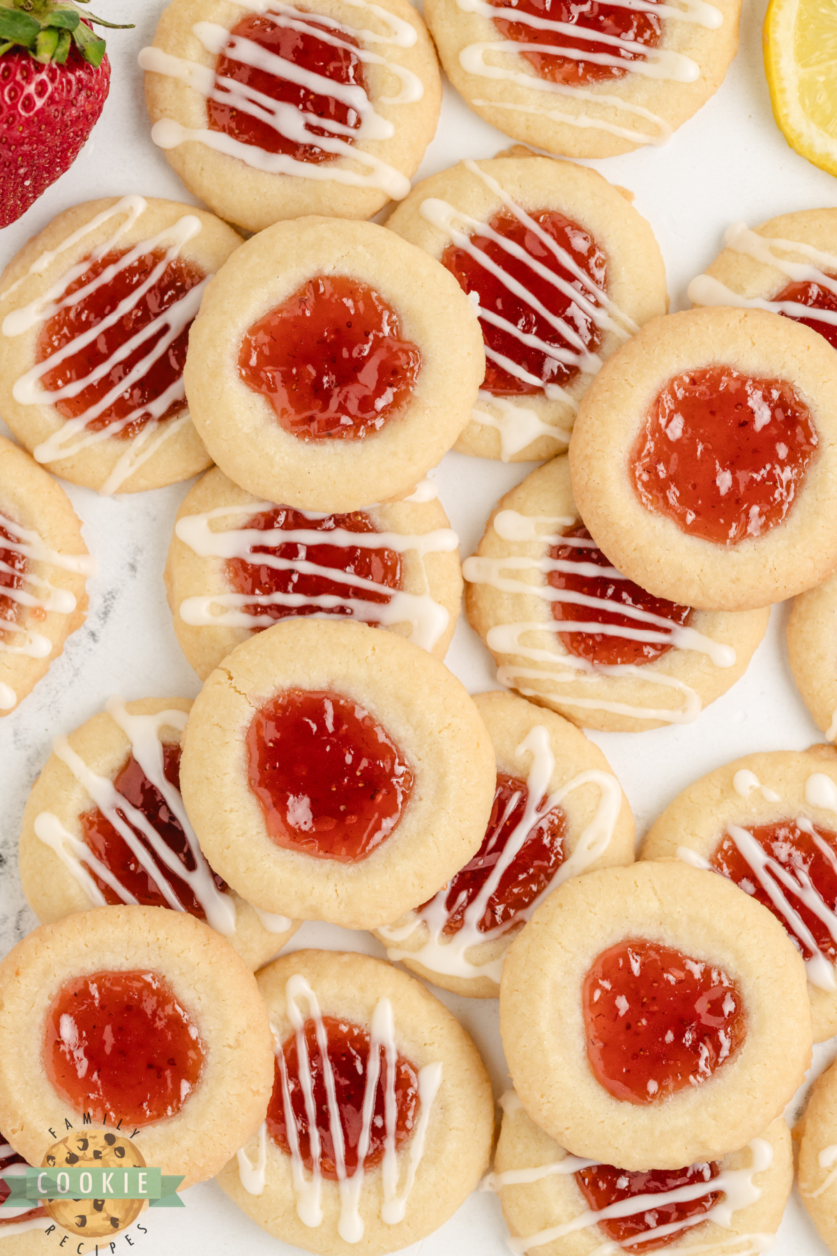 Strawberry Lemon Thumbprint Cookies are buttery, citrusy, and sweet—filled with jam and topped with a tangy lemon glaze!