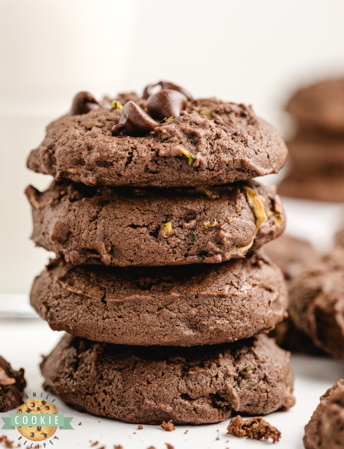 A stack of soft chocolate zucchini cookies with melty chocolate chips visible throughout.
