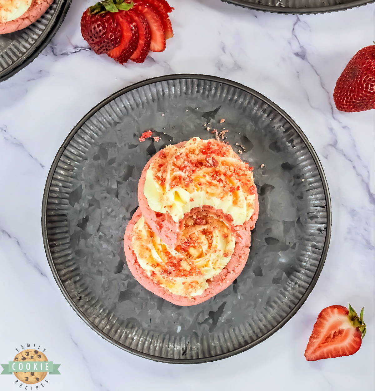 Strawberry cookies with vanilla frosting and strawberry streusel on top.