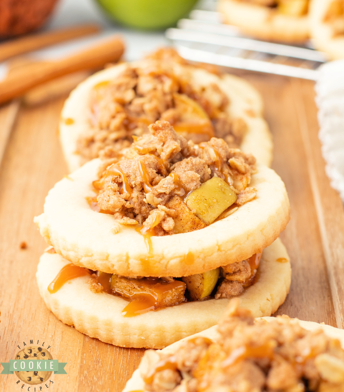 Apple Crumble Cookies are filled with cinnamon-spiced apples, topped with a buttery oat crumble, and drizzled with caramel.