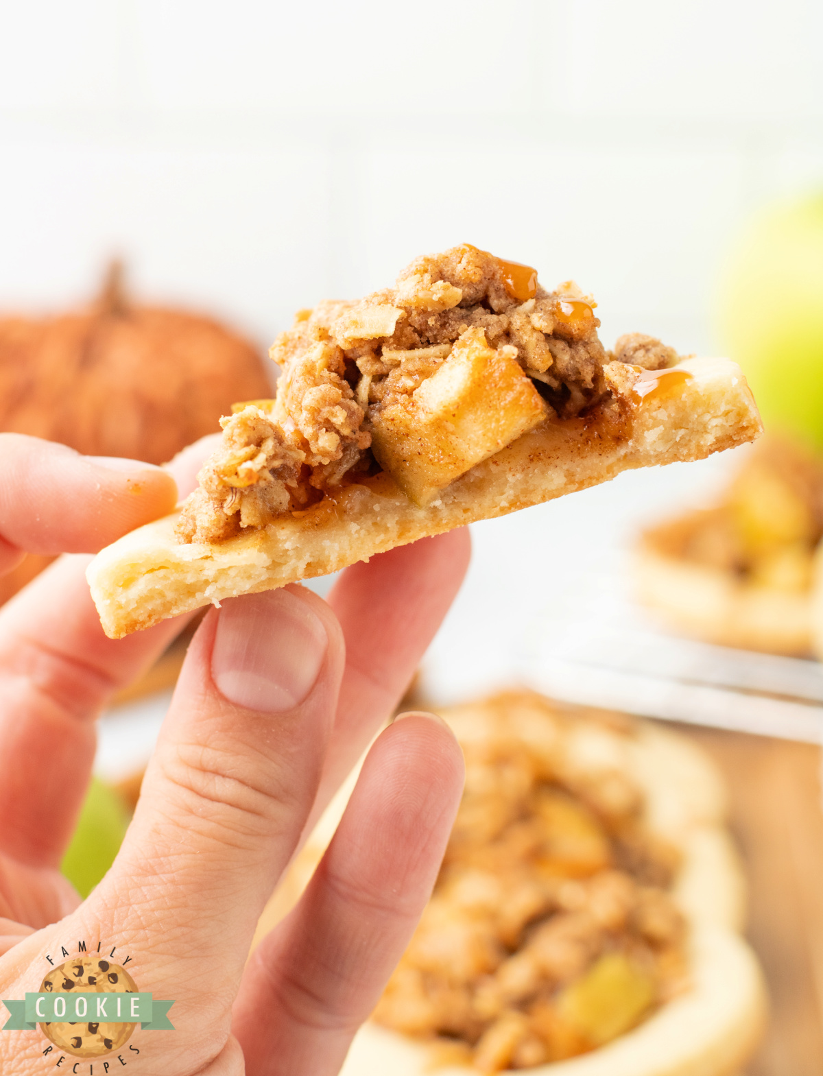 Hand holding half of an Apple Crumble Cookie.