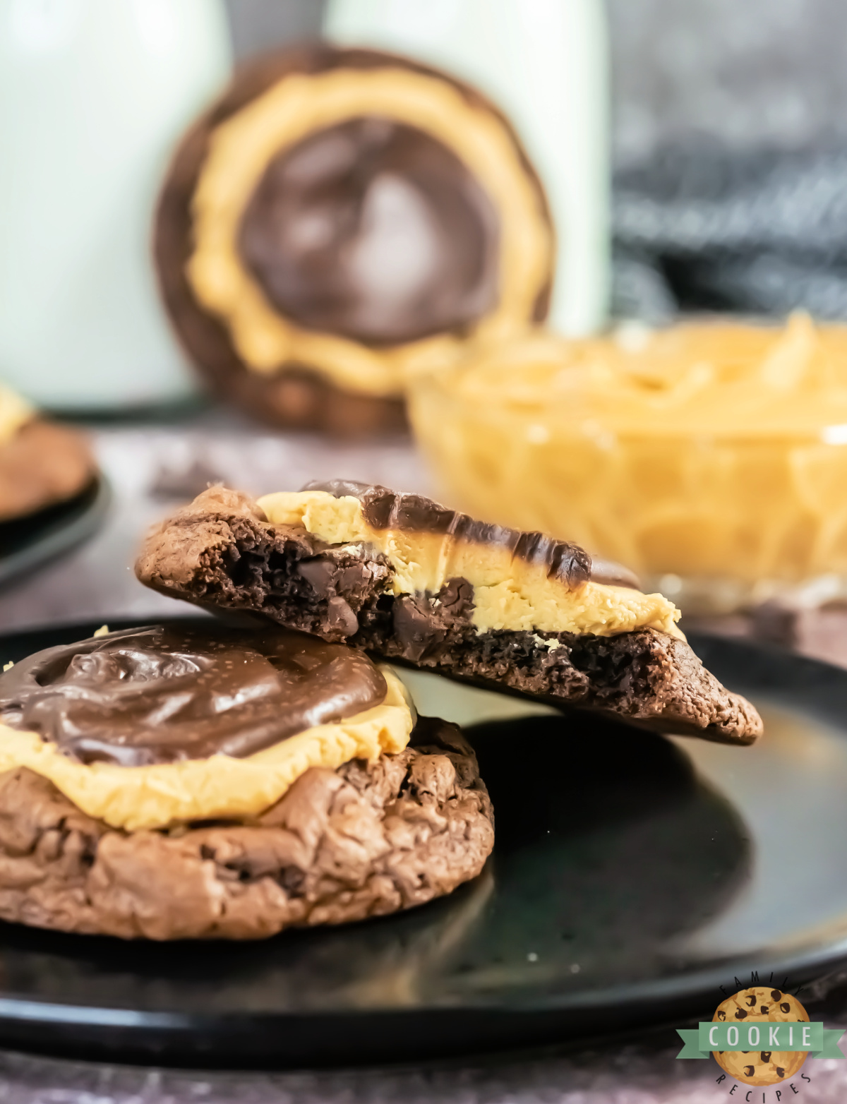 Thick chocolate cookie topped with a peanut butter layer and chocolate ganache.