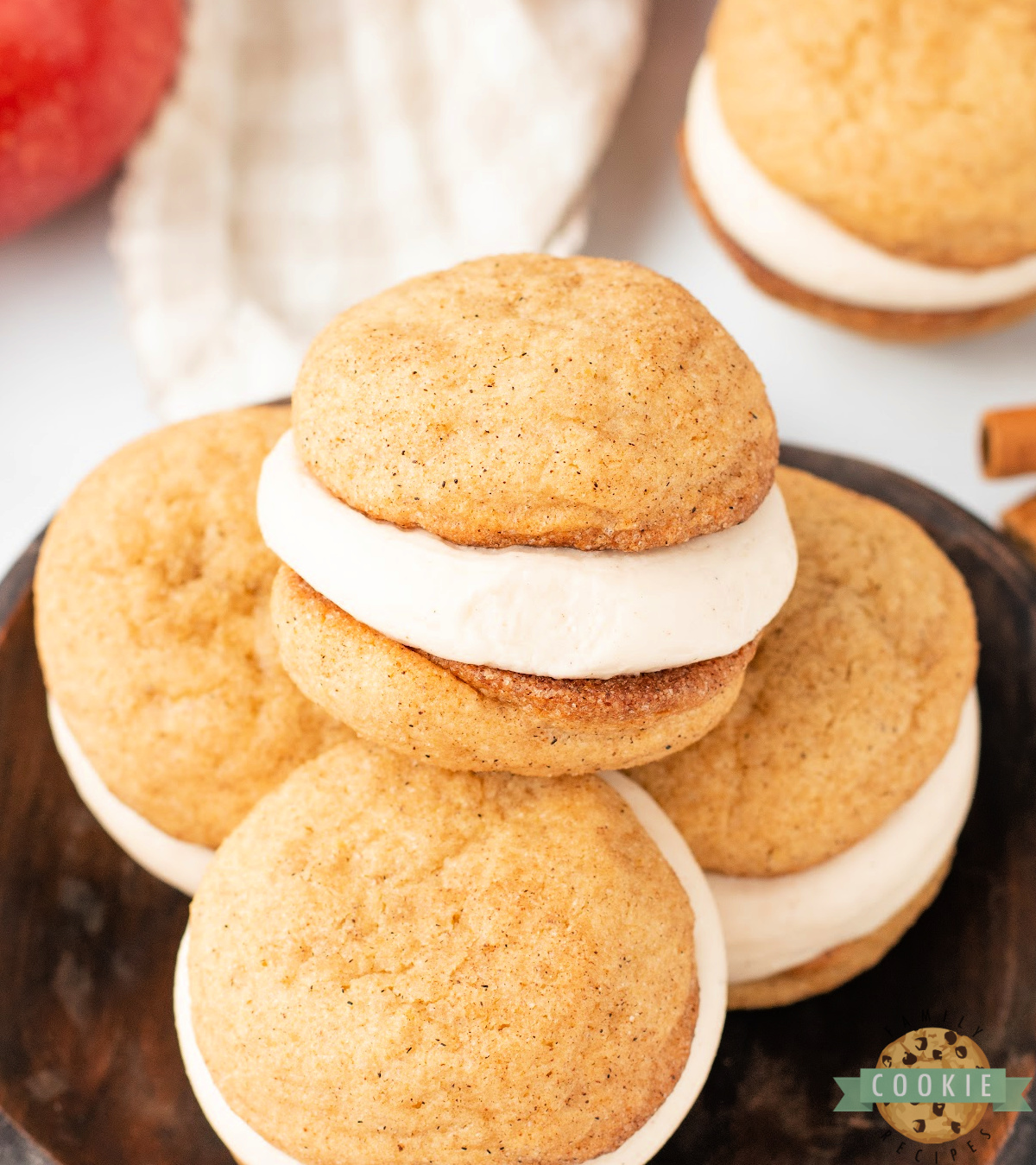 Close-up of Apple Cider Snickerdoodle Cream Pies with spiced cookies and creamy apple cider frosting filling.
