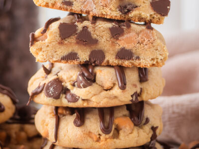 stack of Scotcheroo Cookies drizzled with chocolate
