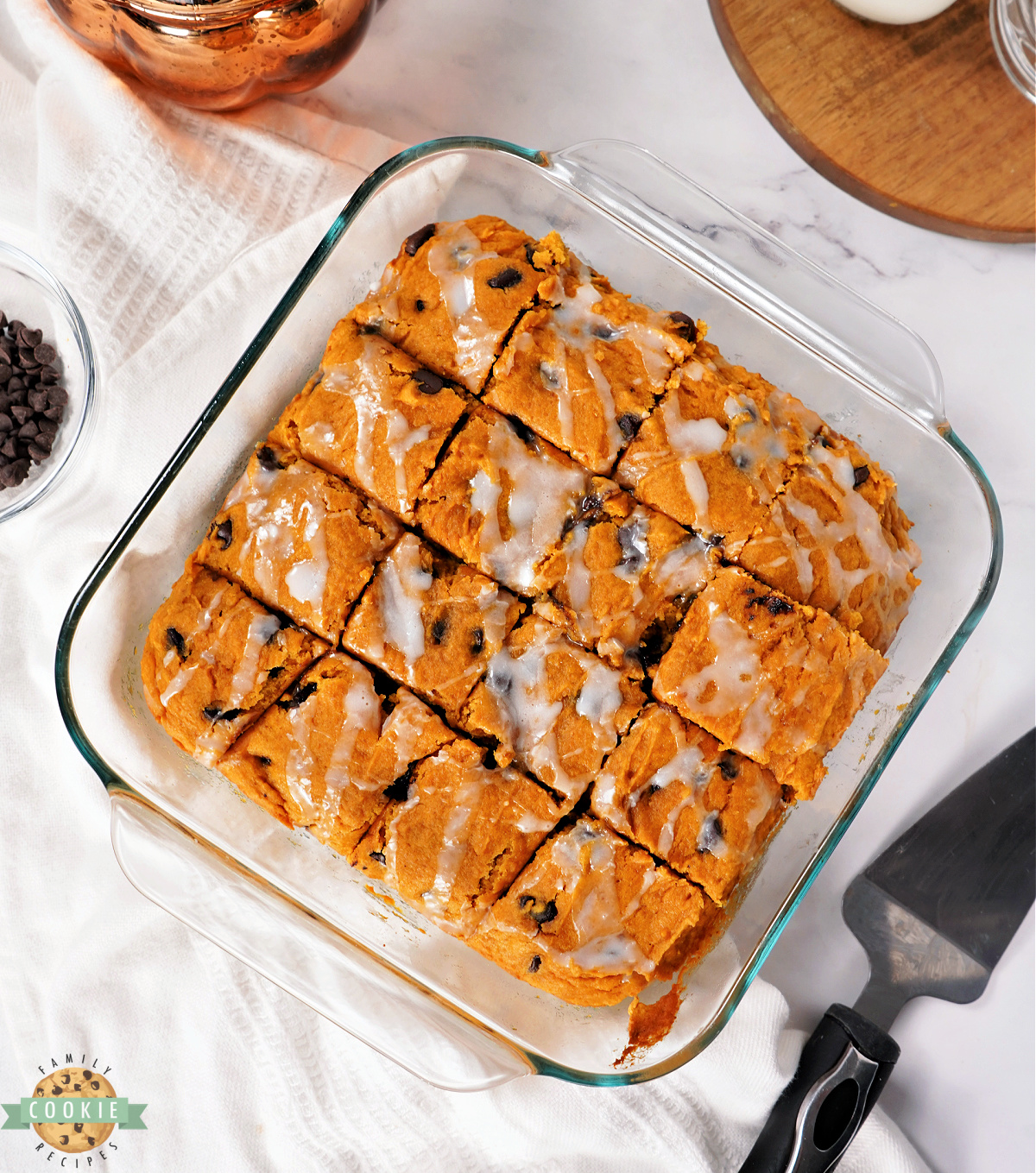 Square pan of pumpkin bars drizzled with glaze.