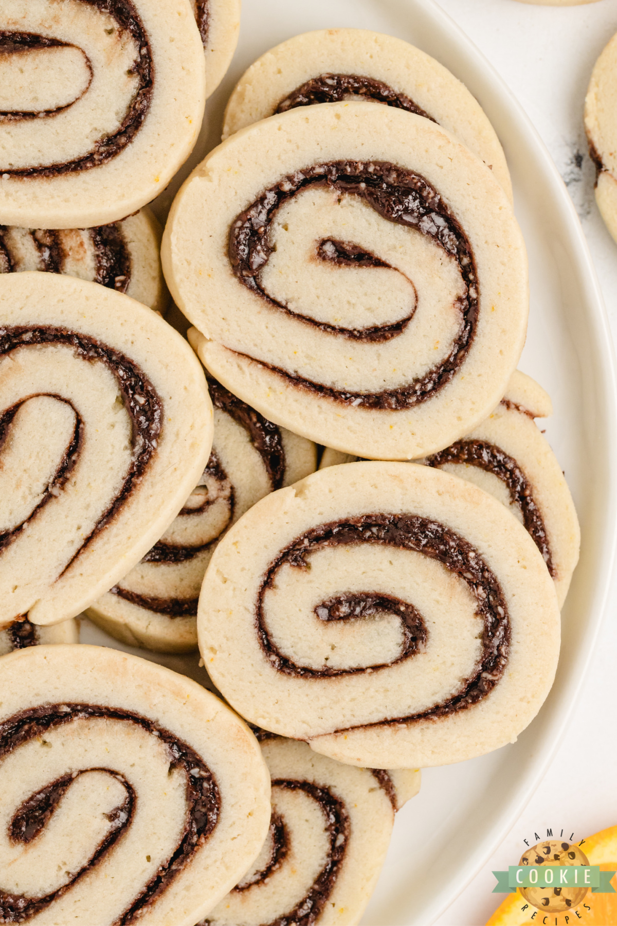 Freshly baked chocolate orange pinwheels on a plate.
