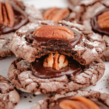 bite taken out of a chocolate pecan crinkle cookie