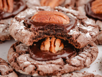 bite taken out of a chocolate pecan crinkle cookie