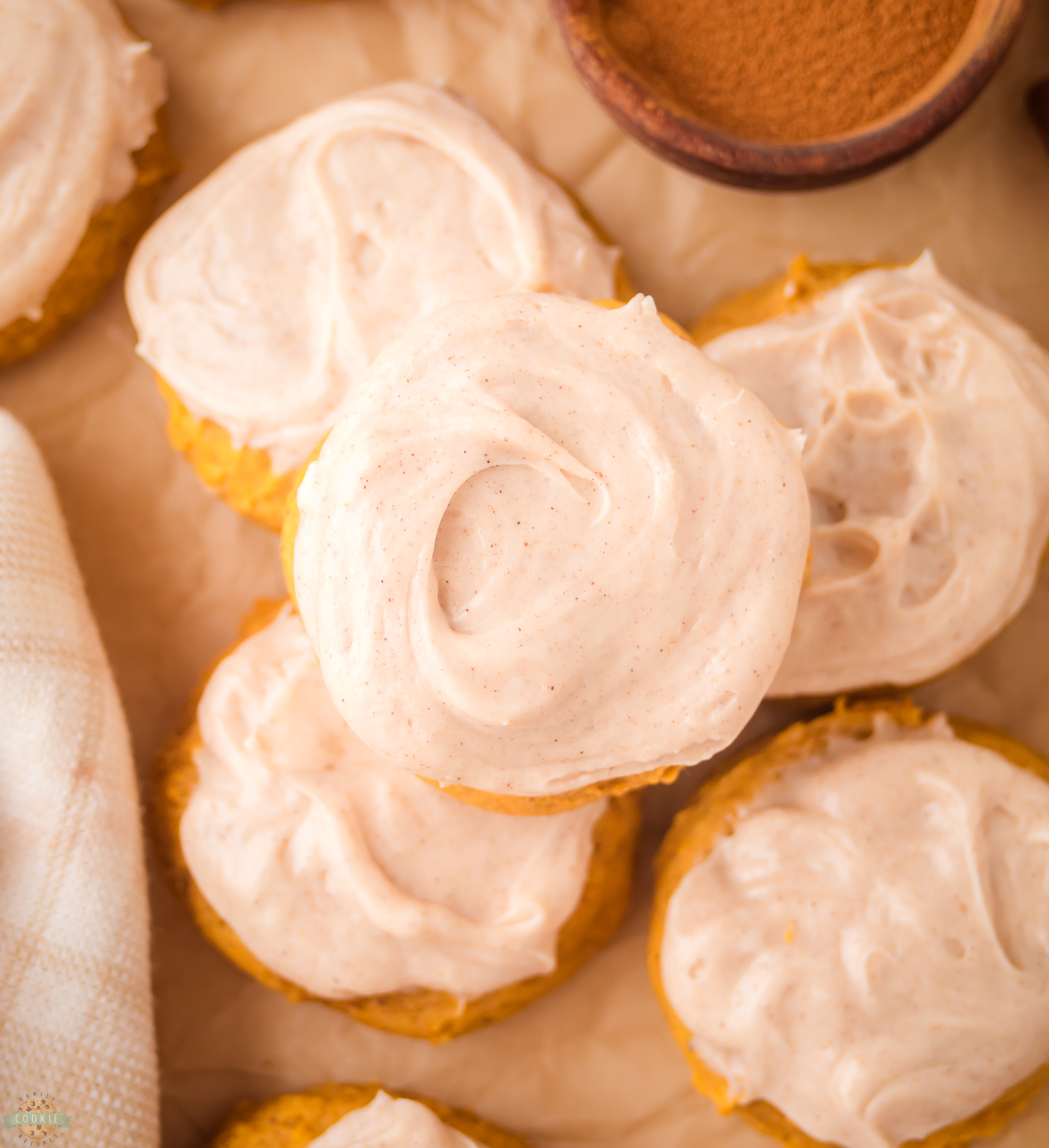 pile of frosted pumpkin cookies