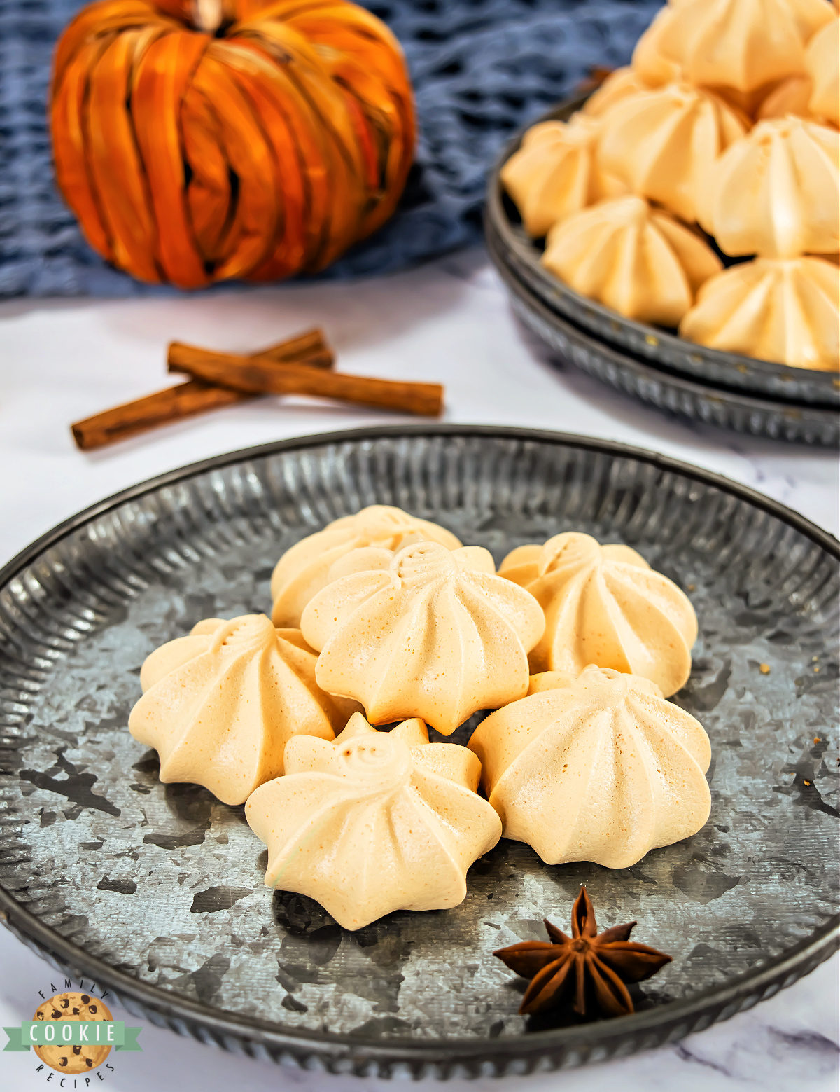 Close-up of piped meringues with crisp ridges and glossy finish.