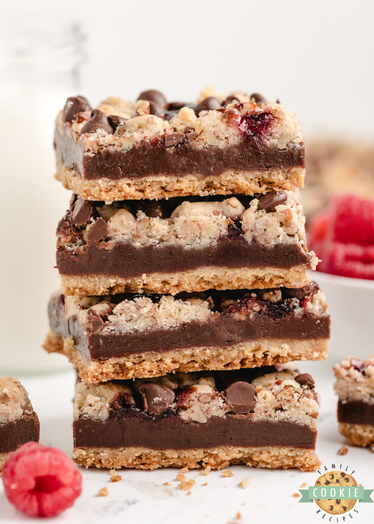 Stack of chocolate raspberry shortbread bars showing layers of crust and crumb topping.