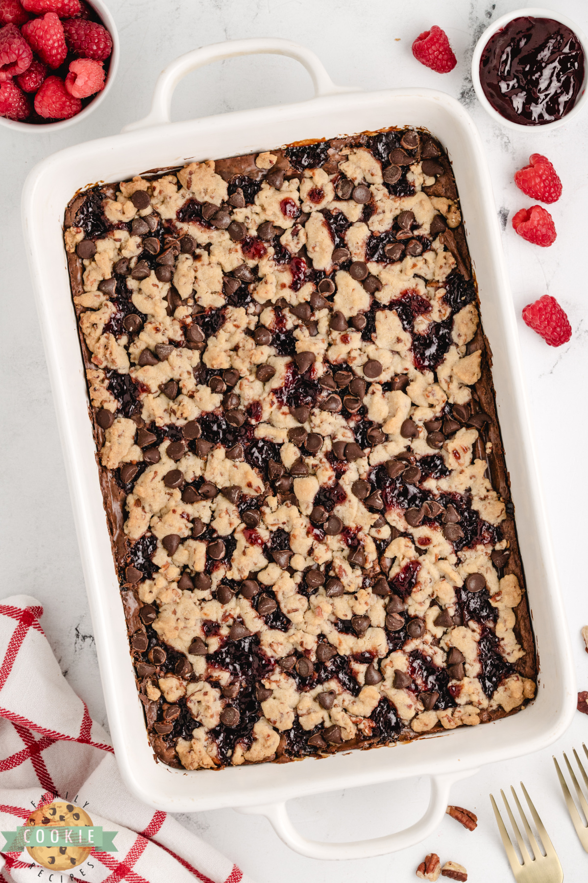 Chocolate raspberry shortbread cookie bars in a 9x13 pan with crumb topping.