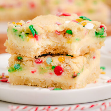 Christmas Cheesecake Sugar Cookie Bars on a white plate