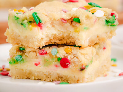 Christmas Cheesecake Sugar Cookie Bars on a white plate