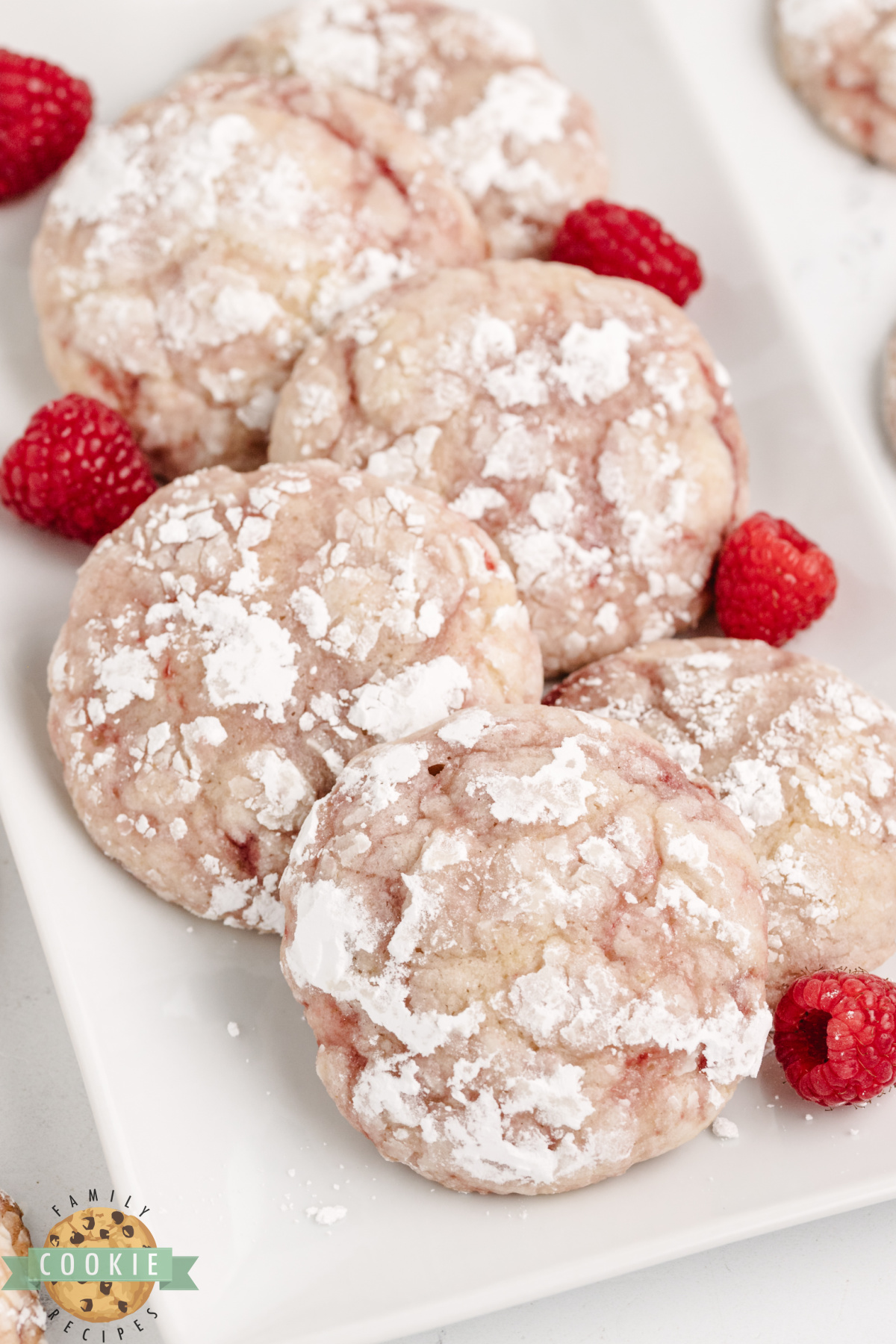 Lemon raspberry crinkle cookies dusted with powdered sugar.