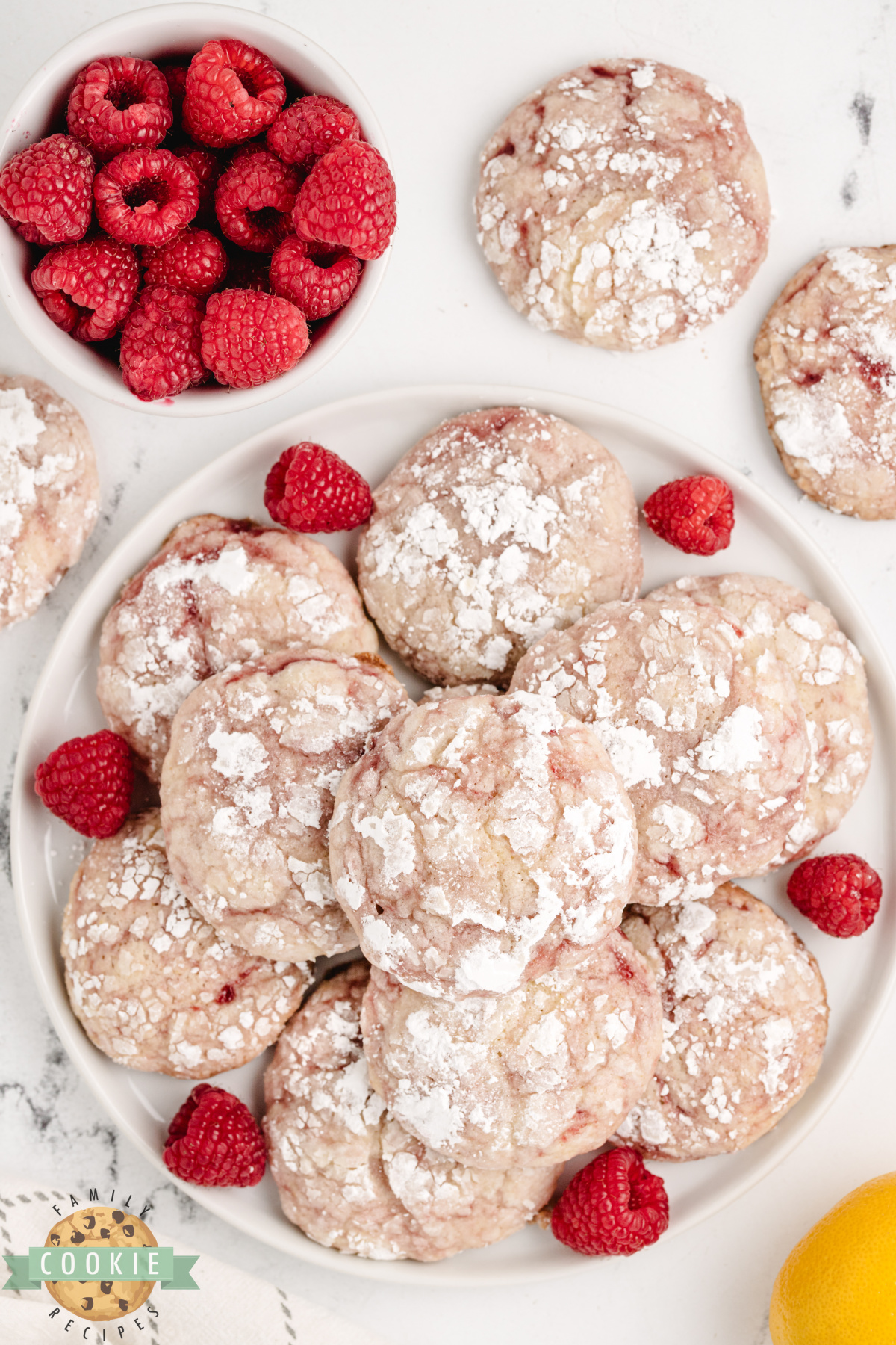 Lemon raspberry cookies with crackly powdered sugar tops.