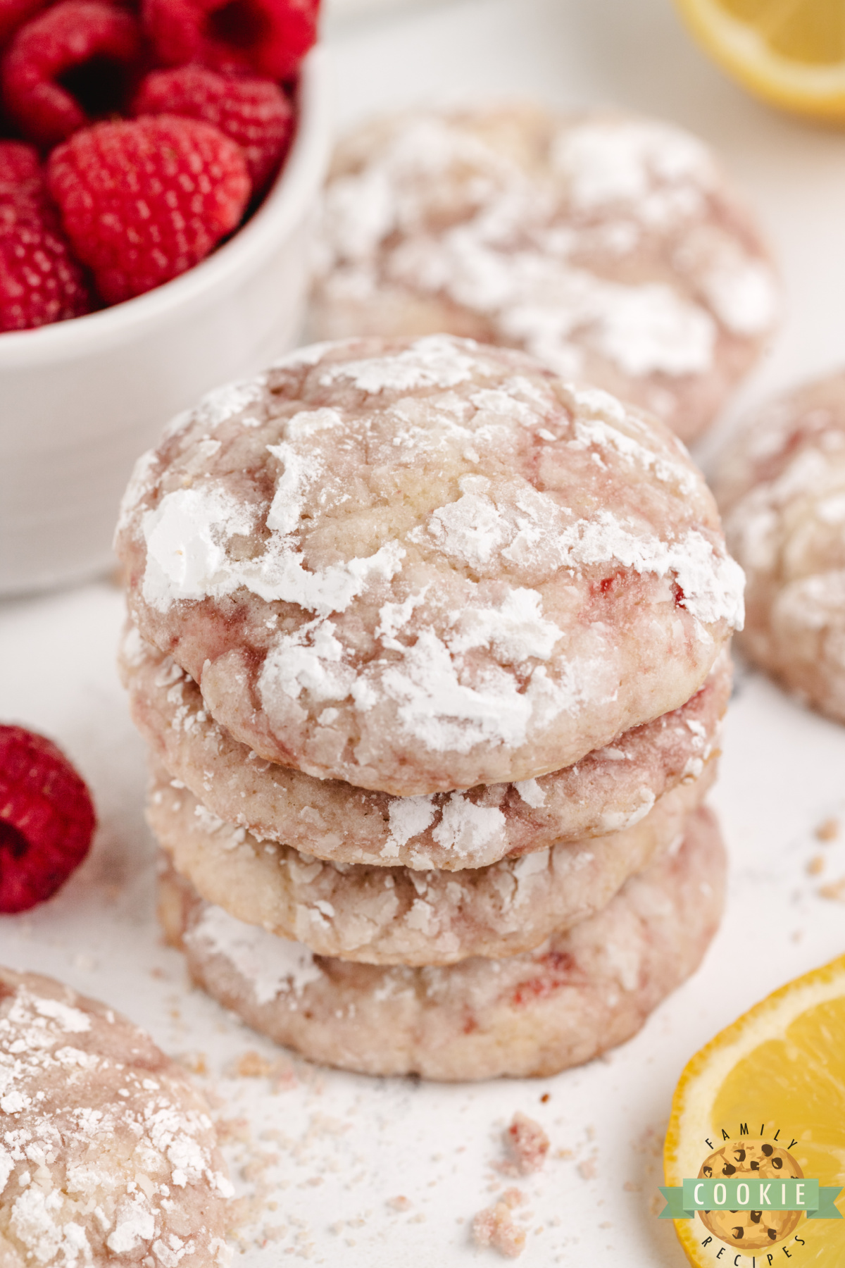 Bakery-style lemon raspberry crinkle cookies stacked in a pile.