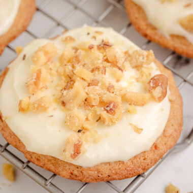 Carrot Cake Cookies topped with a cream cheese frosting on a cooling rack