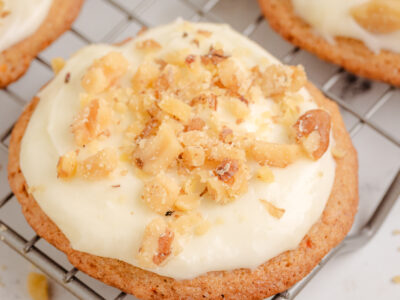 Carrot Cake Cookies topped with a cream cheese frosting on a cooling rack