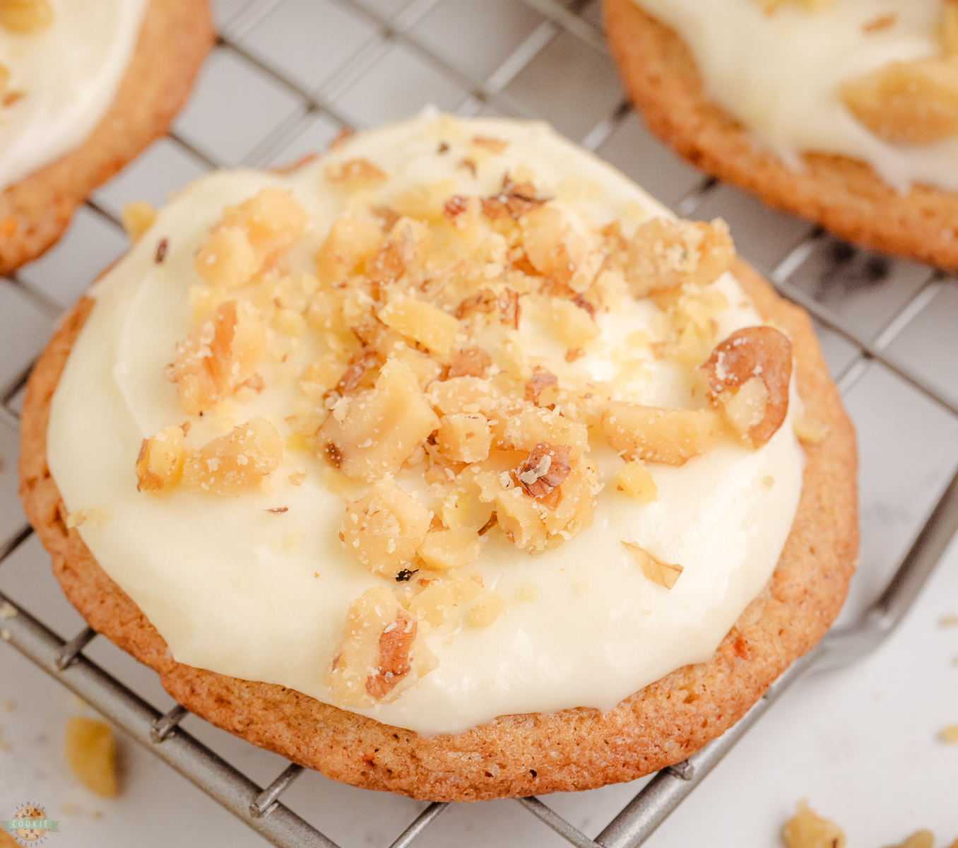 Carrot Cake Cookies topped with a cream cheese frosting on a cooling rack