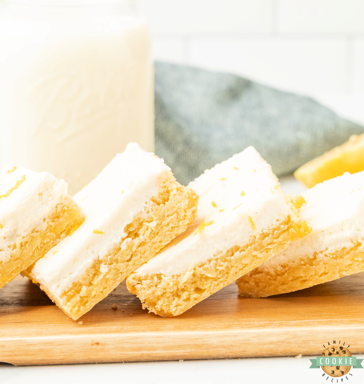 Lemon cookie bars cut into squares and topped with cream cheese frosting.