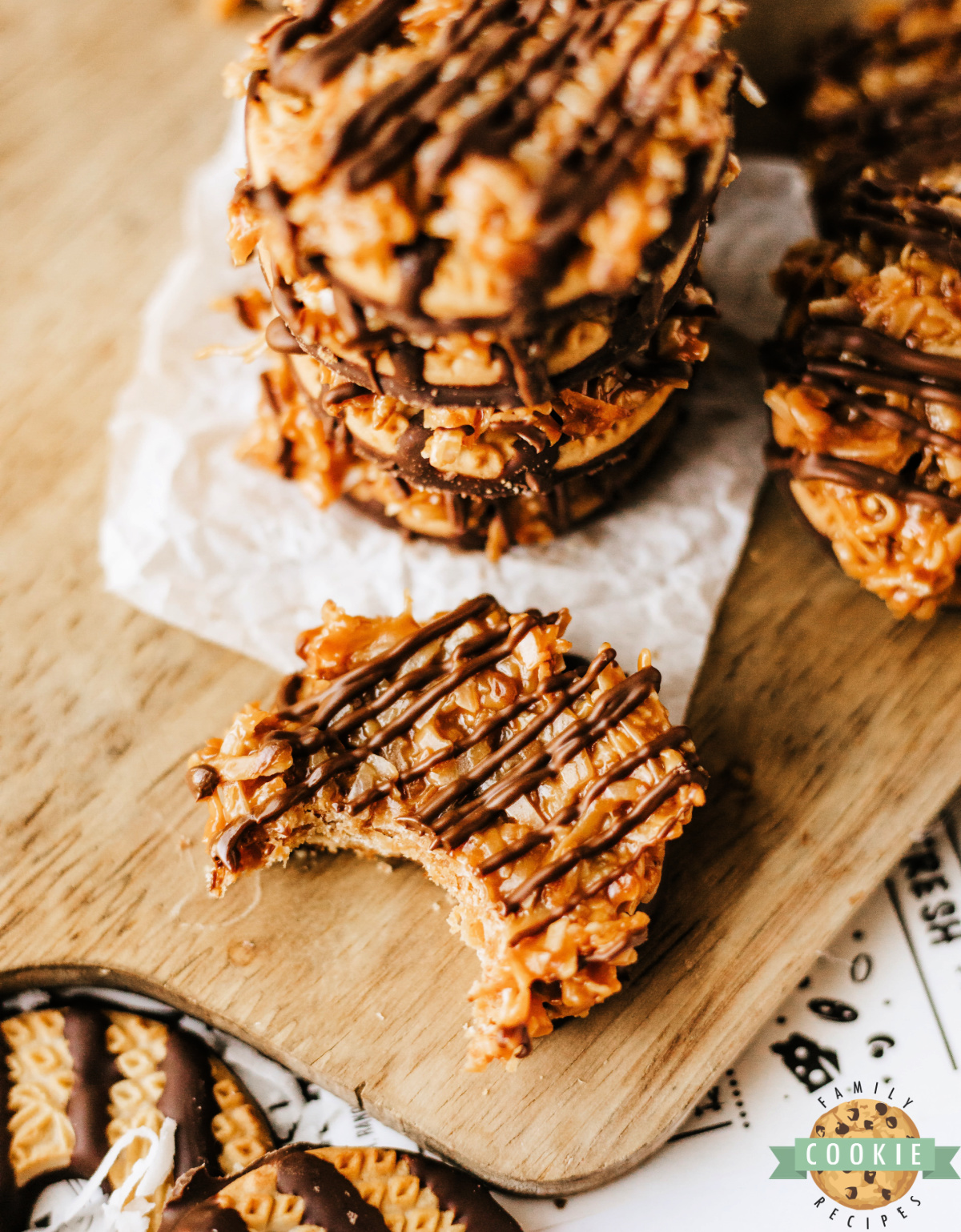 Close-up of a no-bake Samoas cookie with caramel, toasted coconut, and chocolate drizzle.