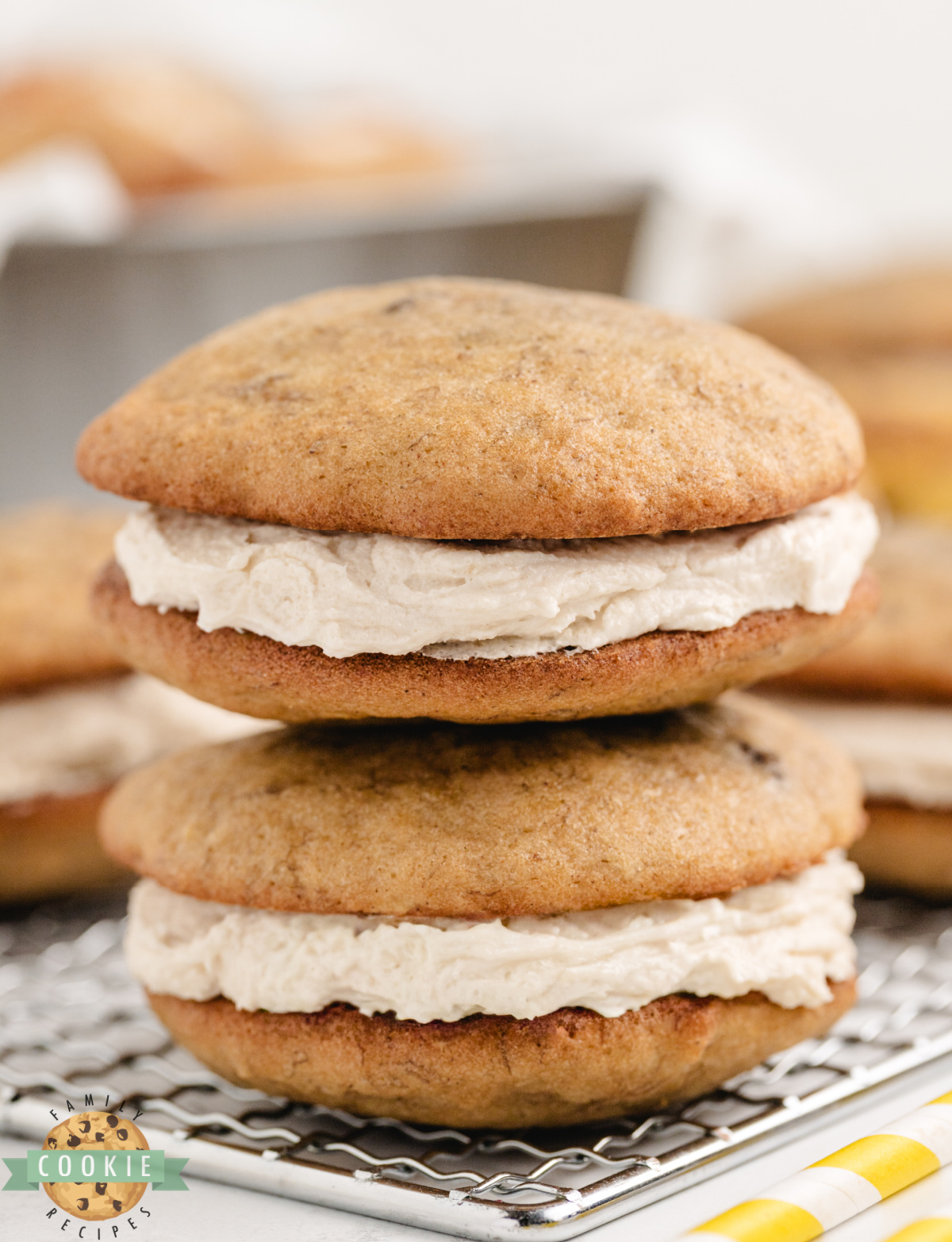 A stack of soft banana bread sandwich cookies with brown sugar frosting.
