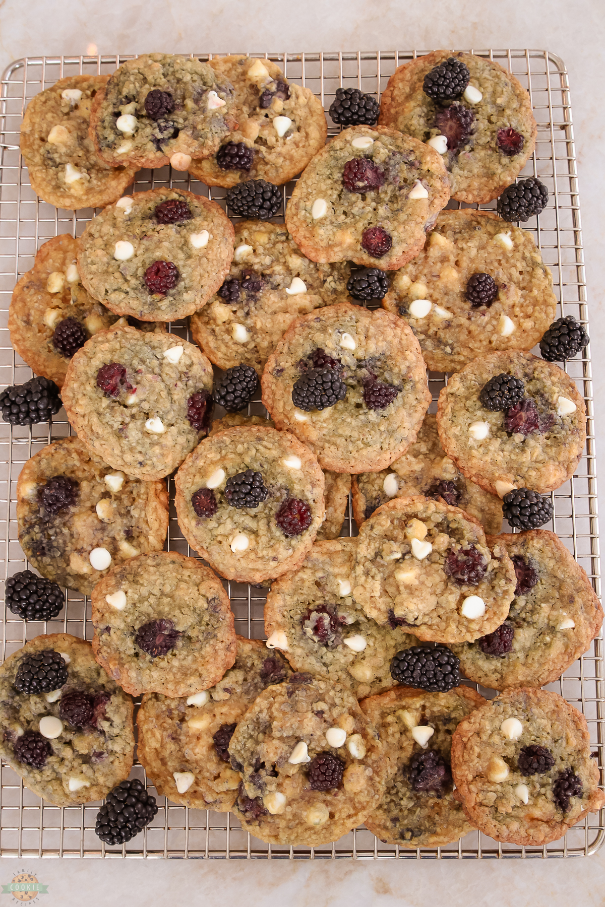 blackberry oatmeal cookies piled on a cooling rack