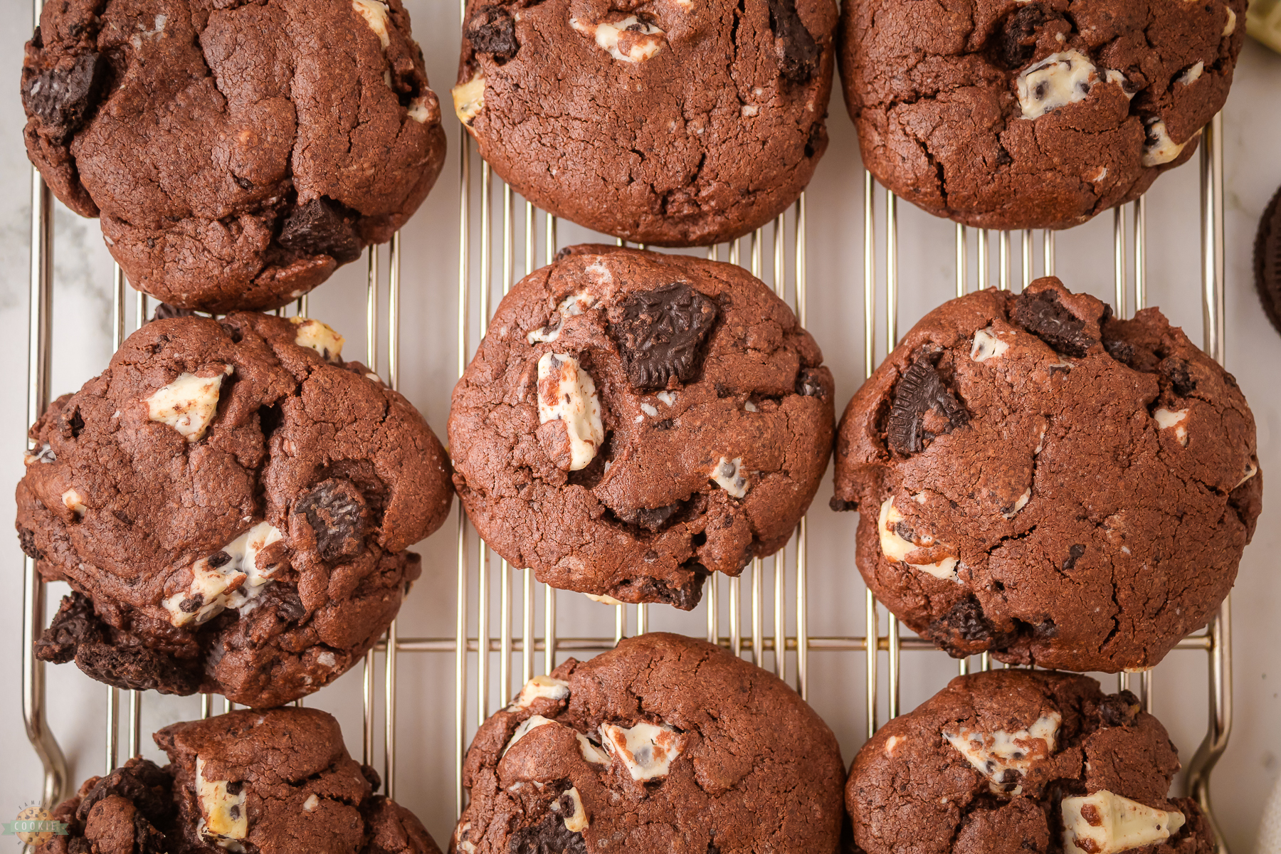 chocolate cookies and cream cookies on a baking sheet