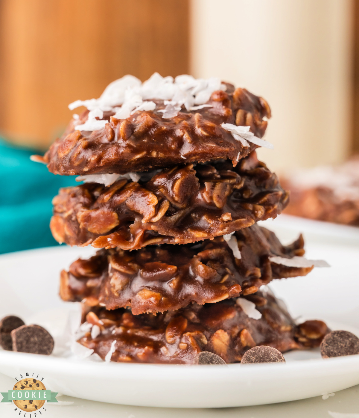 Batch of no bake coconut cookies stacked on a white plate.