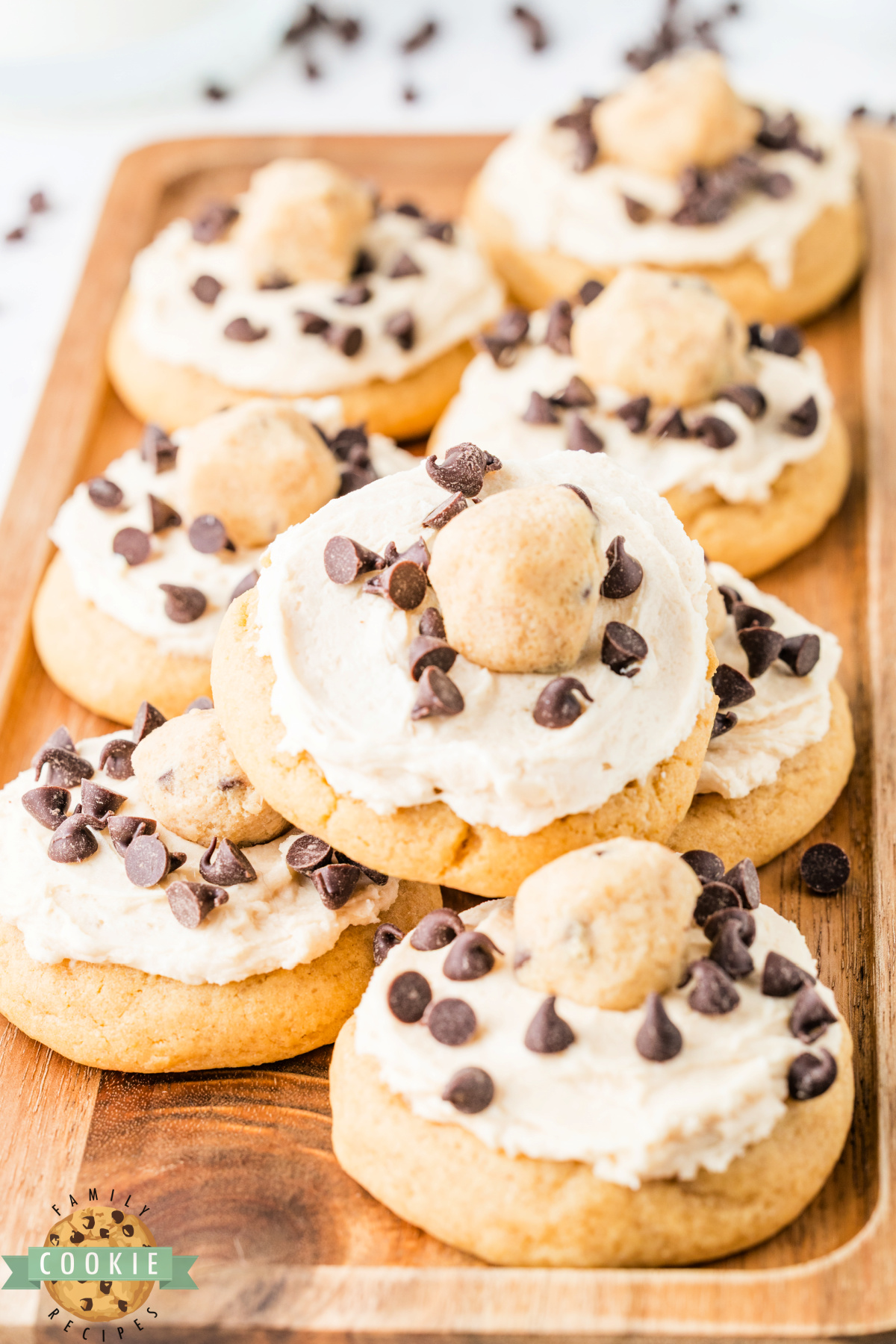 Batch of cookie dough frosted cookies loaded with edible cookie dough pieces and mini chocolate chips