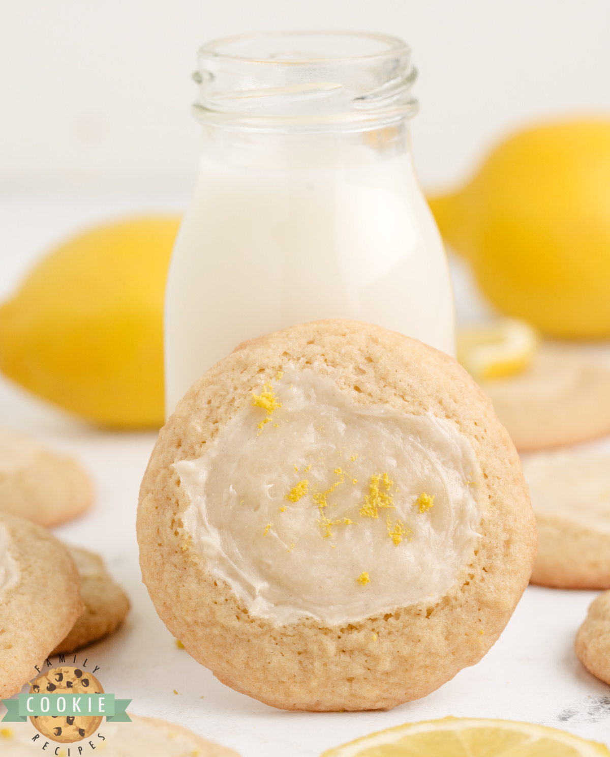 Lemon Cheesecake Cookie topped with lemon zest and propped up next to a bottle of milk.